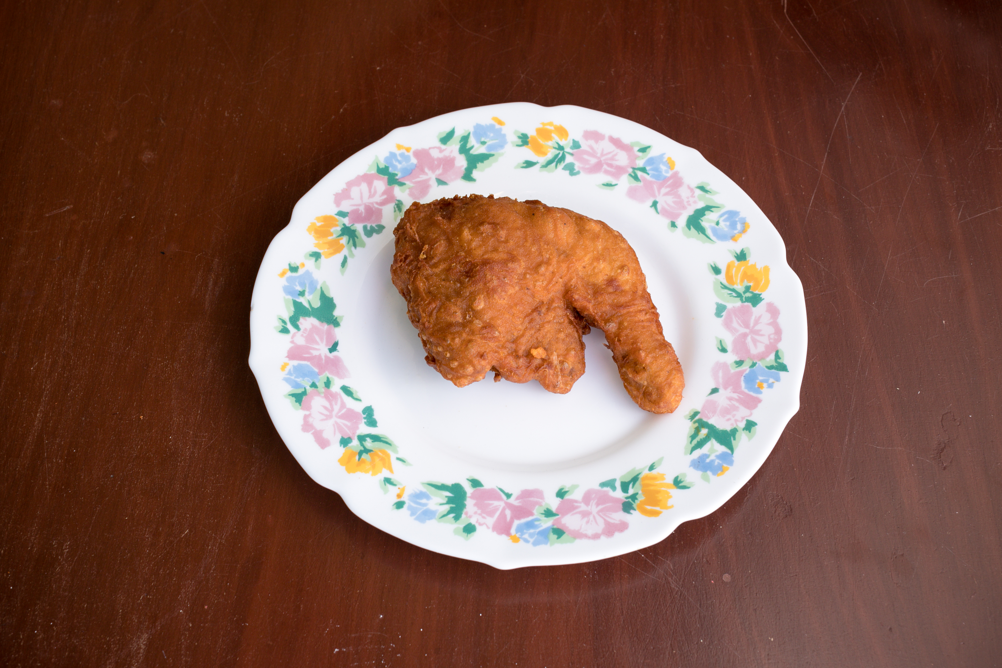 fried chicken on floral ceramic plate